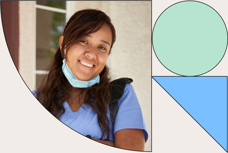  Nurse smiling at camera while wearing a bookbag and a mask that is pulled down to show her smile